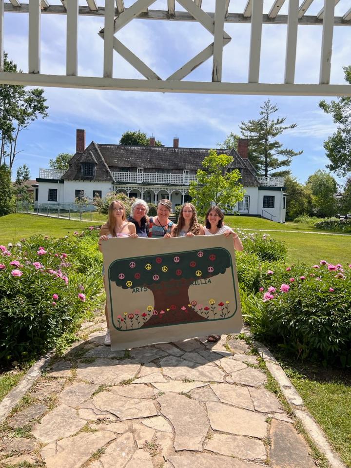 Arts for Peace Orillia - photo of volunteer organizers with banner